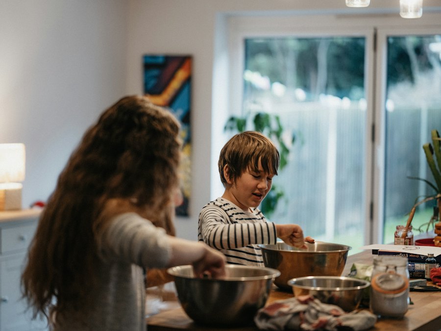 Two children cooking together in a kitchen