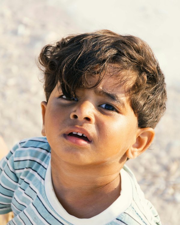 Boy with curly hair in a striped shirt